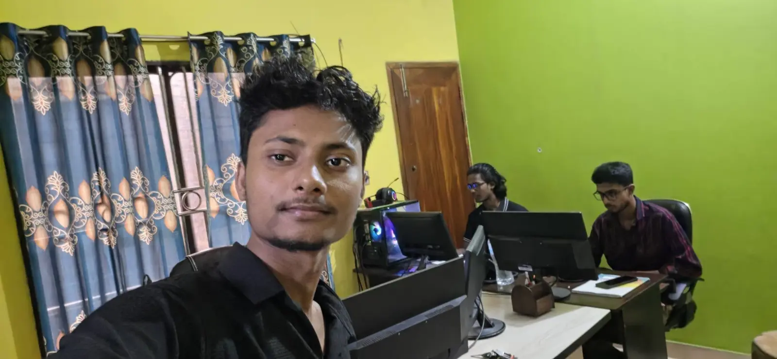 Awshan and colleagues in their office with desktop workstations